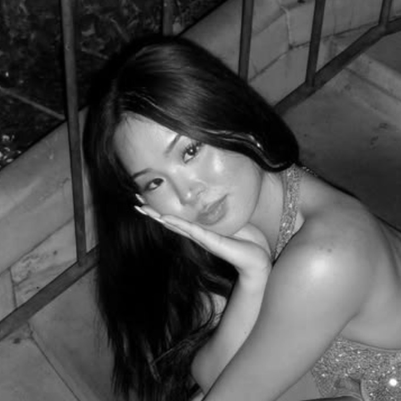 Mischa sitting on outdoor steps, the inspiration for her self-portrait